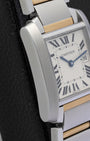 Left side view of the iconic rectangular case and vertically satin-brushed steel brancards on a midsize Cartier Tank watch
