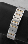 integrated two-tone watch link bracelet on a Cartier Tank Française showing the 18k yellow gold center links