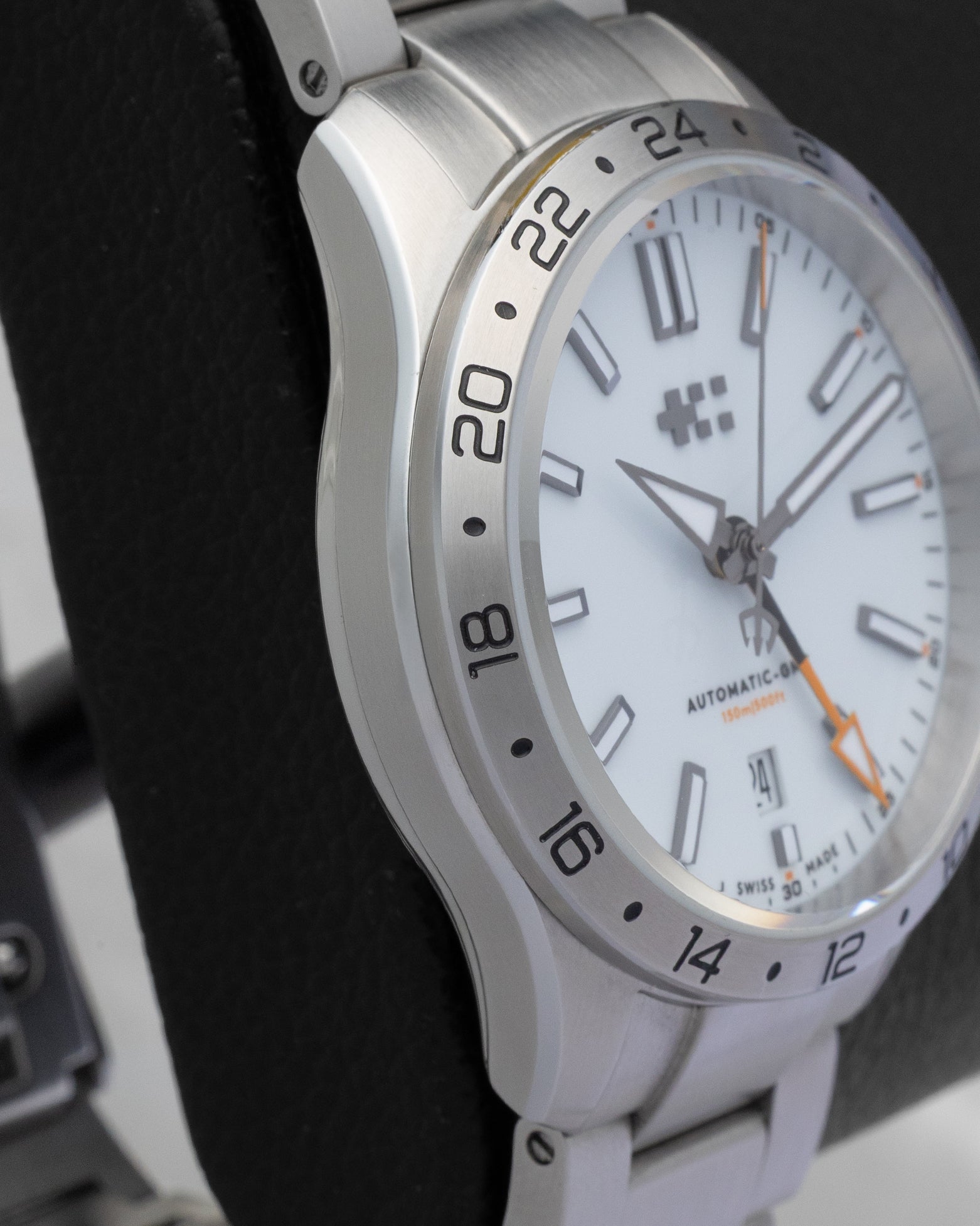 Close-up of the 24-hour fixed bezel and distinct orange GMT hand on a Christopher Ward C63 Sealander watch