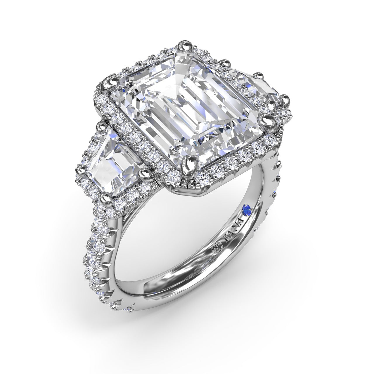 Fana emerald cut halo three stone engagement ring, style S4280 with custom-framed trapezoid diamond side stones and a pavé diamond band