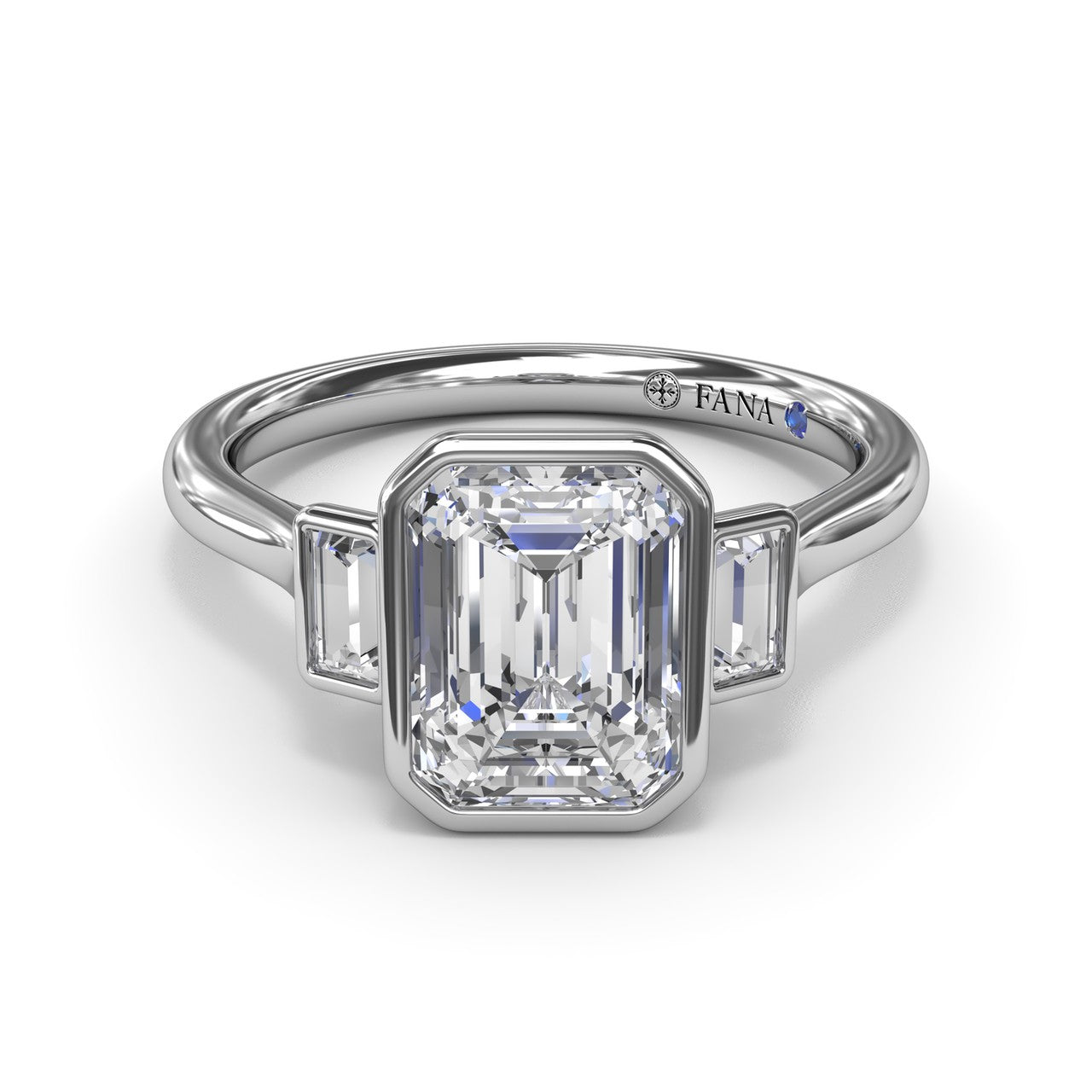 Studio front-facing view of the Fana S4278 three stone ring, emphasizing the protective metal borders enclosing the emerald cut center and baguette diamonds