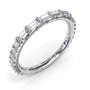 An angled studio view of the Fana baguette diamond eternity ring, showing the side profile detailing and the signature blue sapphire inside the inner band