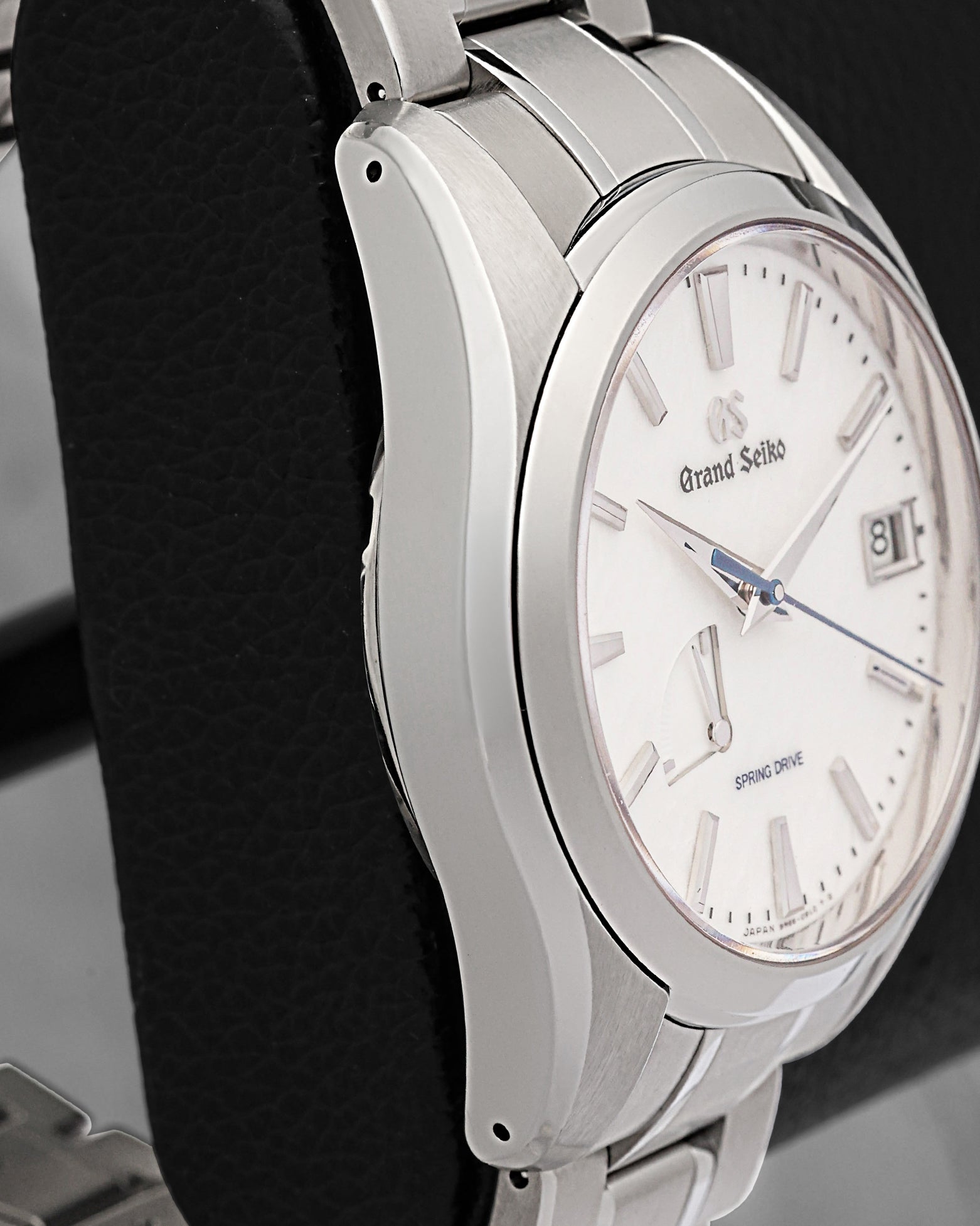 Left-side studio profile view capturing the complex, multi-faceted case lines and the transition between satin-brushed and Zaratsu-polished surfaces on the lightweight titanium chassis