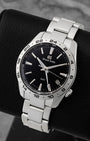 Angled view of pre-owned Grand Seiko Sport GMT SBGN027G featuring a monochrome black dial, white GMT hand, Zaratsu-polished hands, and fixed 24-hour bezel.
