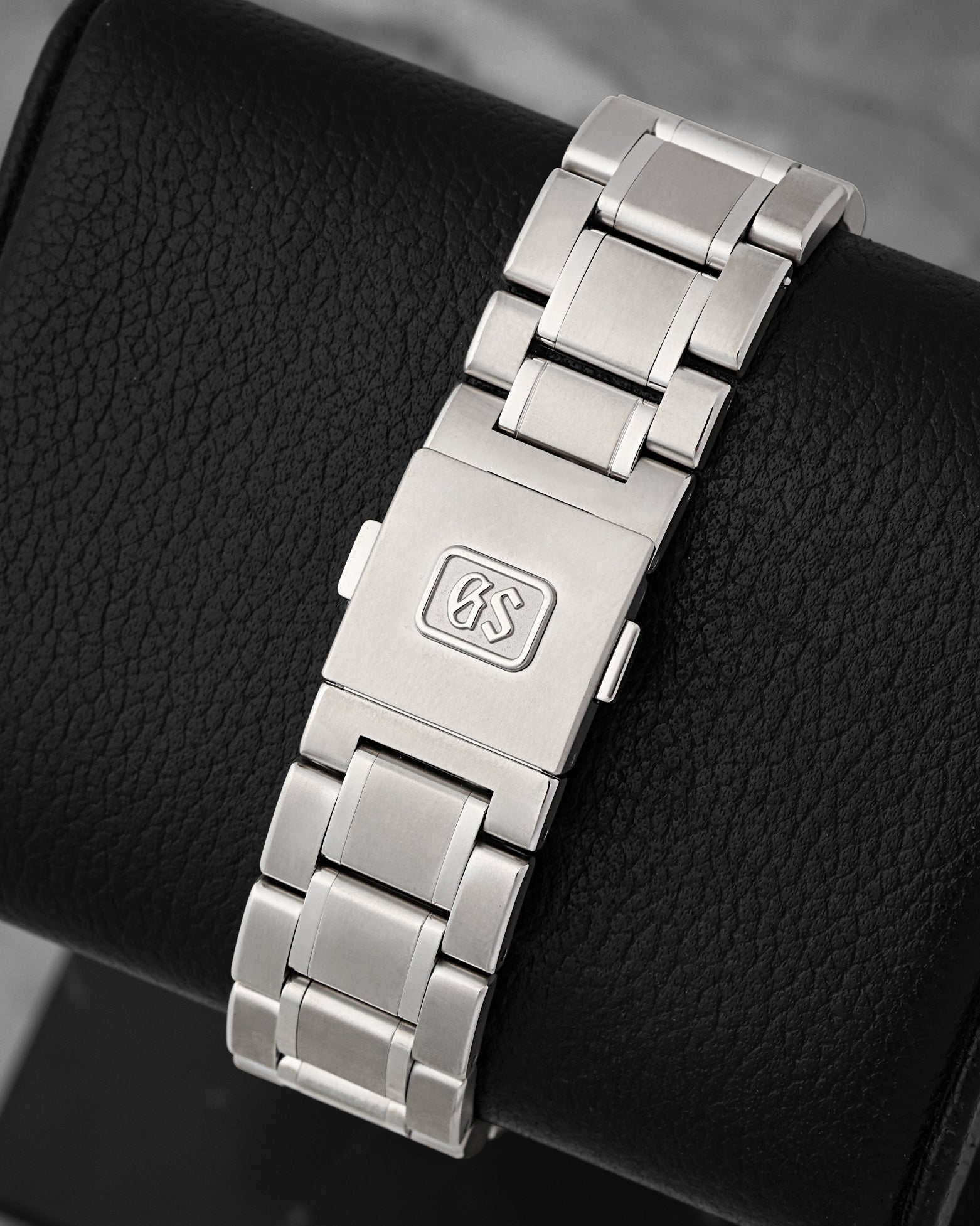 Rear view of the high-intensity titanium bracelet focusing on the secure three-fold deployment clasp featuring a cleanly recessed, solid GS logo emblem