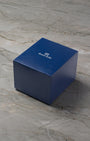 A high-angle three-quarter shot of the official minimalist matte navy blue Grand Seiko watch box resting closed over a light grey marble surface