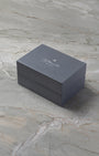 angled overview of the textured slate grey H. Moser & Cie. luxury watch presentation box on a marble surface