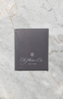 dark charcoal gray H. Moser & Cie. official user manual and instruction booklet displayed flat on marble