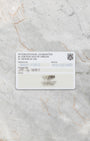 official H. Moser & Cie. international warranty and certificate of origin paper card resting flat on a light gray marble surface