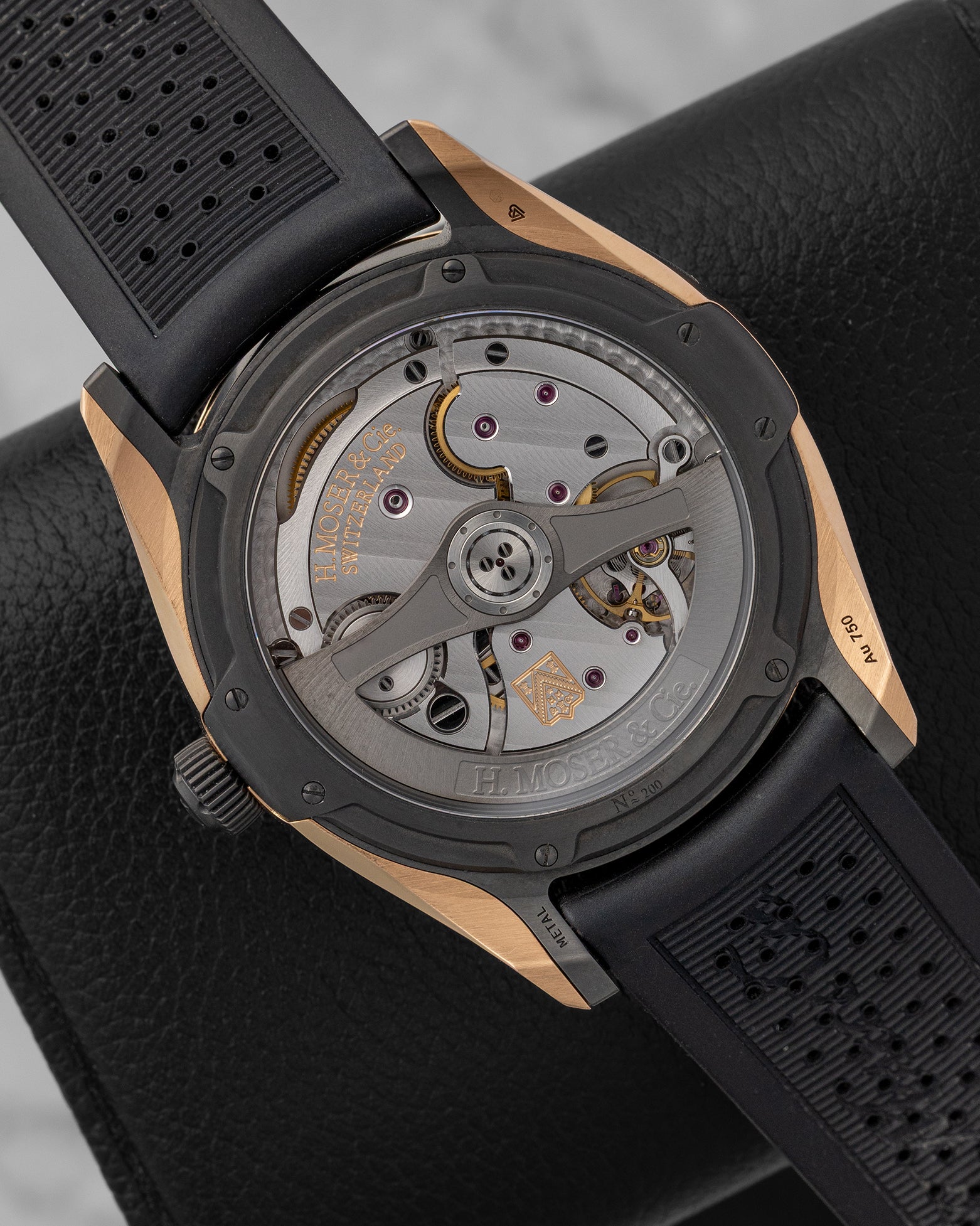 sapphire crystal exhibition caseback of the H. Moser Pioneer watch revealing the decorated in-house caliber HMC 200 automatic movement and rotor