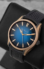 angled top-down overview of the 43mm H. Moser Pioneer 3200-0903 watch highlighting the 18k red gold case bezel and sunburst blue gradient dial