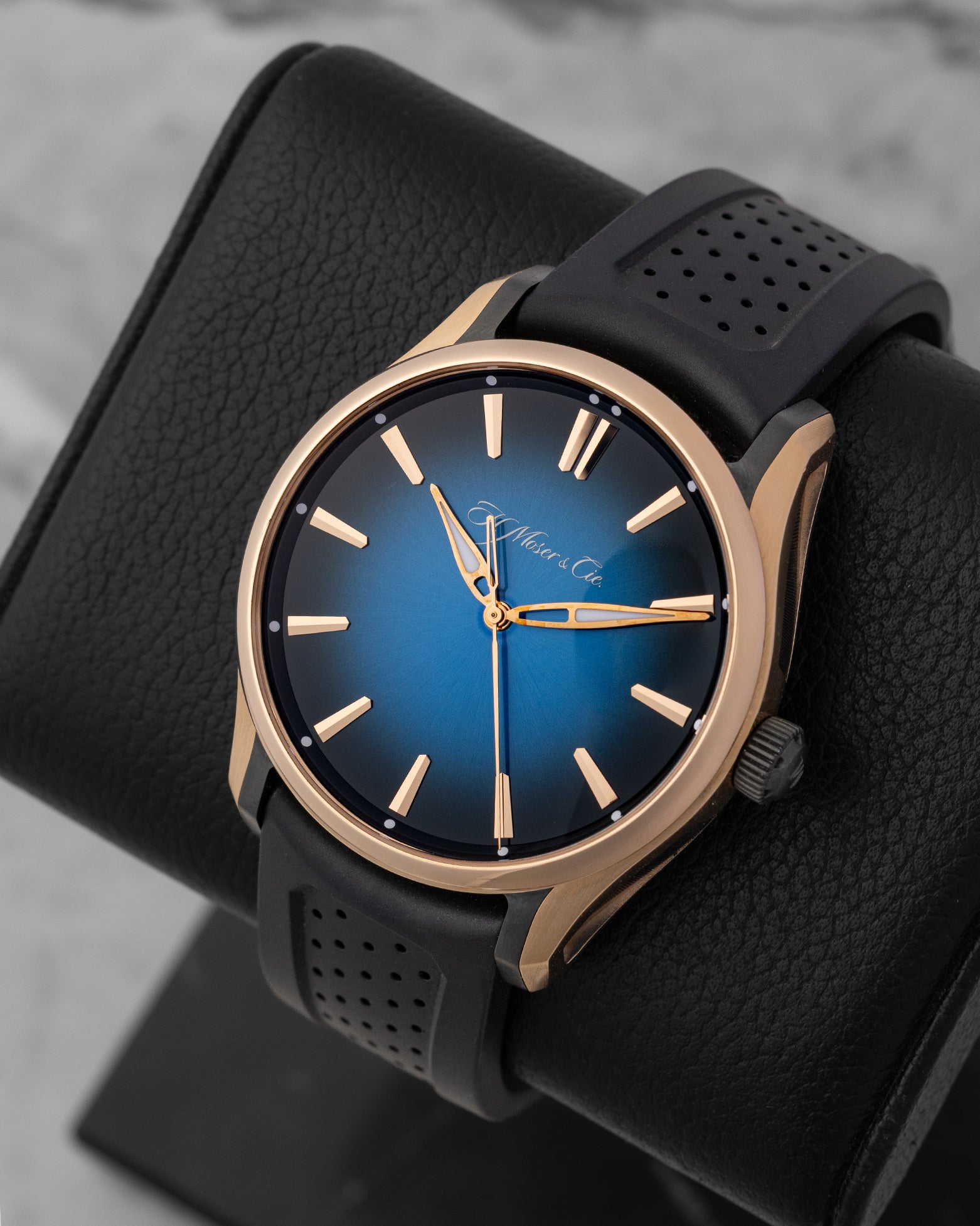 angled top-down overview of the 43mm H. Moser Pioneer 3200-0903 watch highlighting the 18k red gold case bezel and sunburst blue gradient dial