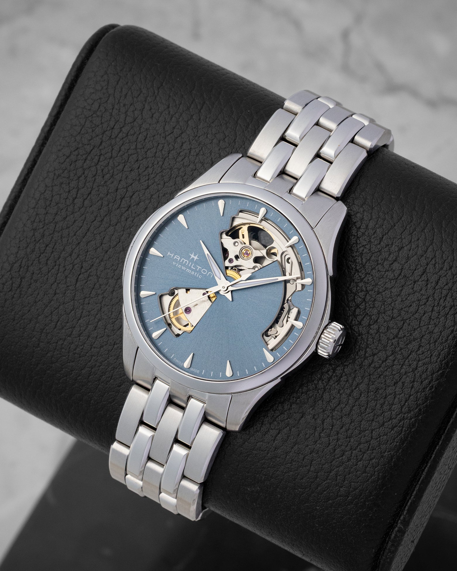 Angled view of a men's Hamilton Jazzmaster Open Heart watch, highlighting the unique skeleton dial cutouts