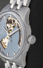 Side profile close-up of a stainless steel Hamilton watch case showing the textured crown with the brand logo