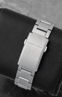 The flat stainless steel folding deployment clasp with an engraved Hamilton logo on a 3-link watch bracelet