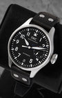 Angled view of pre-owned IWC Big Pilot IW501001 featuring a black dial, white Arabic numerals, date window, and power reserve display