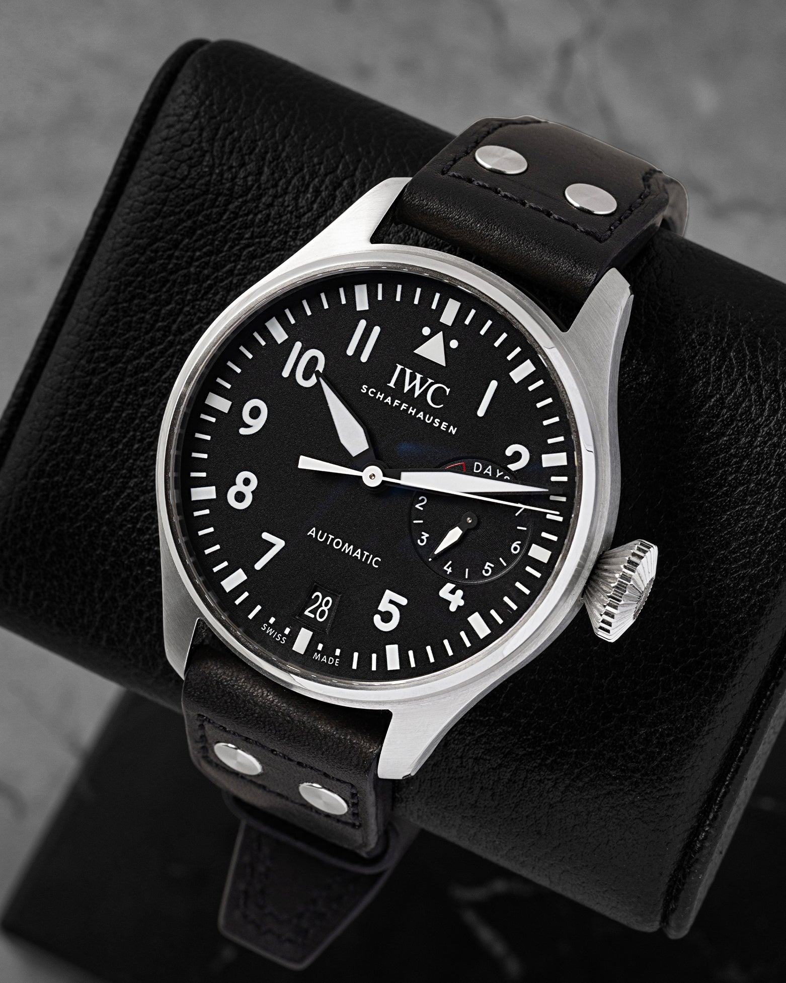 Angled view of pre-owned IWC Big Pilot IW501001 featuring a black dial, white Arabic numerals, date window, and power reserve display