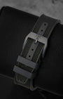 Rear perspective of the black rubber strap with textile inlay, secured by a matching matte black Ceratanium pin tang buckle