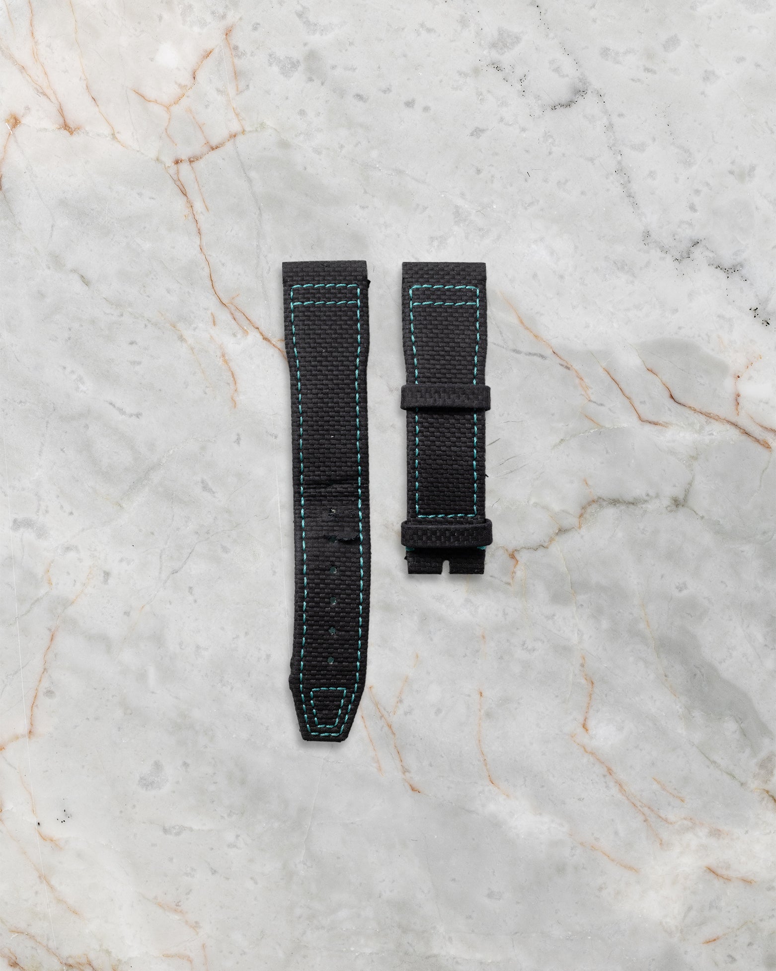 The secondary official black embossed calfskin leather strap featuring the integrated IWC EasX-CHANGE quick release system
