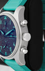 Side profile view of the sandblasted titanium case showing the fluted crown and twin ergonomic piston chronograph pushers