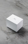 A closed clean white rectangular IWC Schaffhausen luxury watch presentation box sitting centered on a grey marble surface