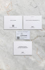 The official IWC international limited warranty card, service manual, and user guide booklets laid flat on a marble background