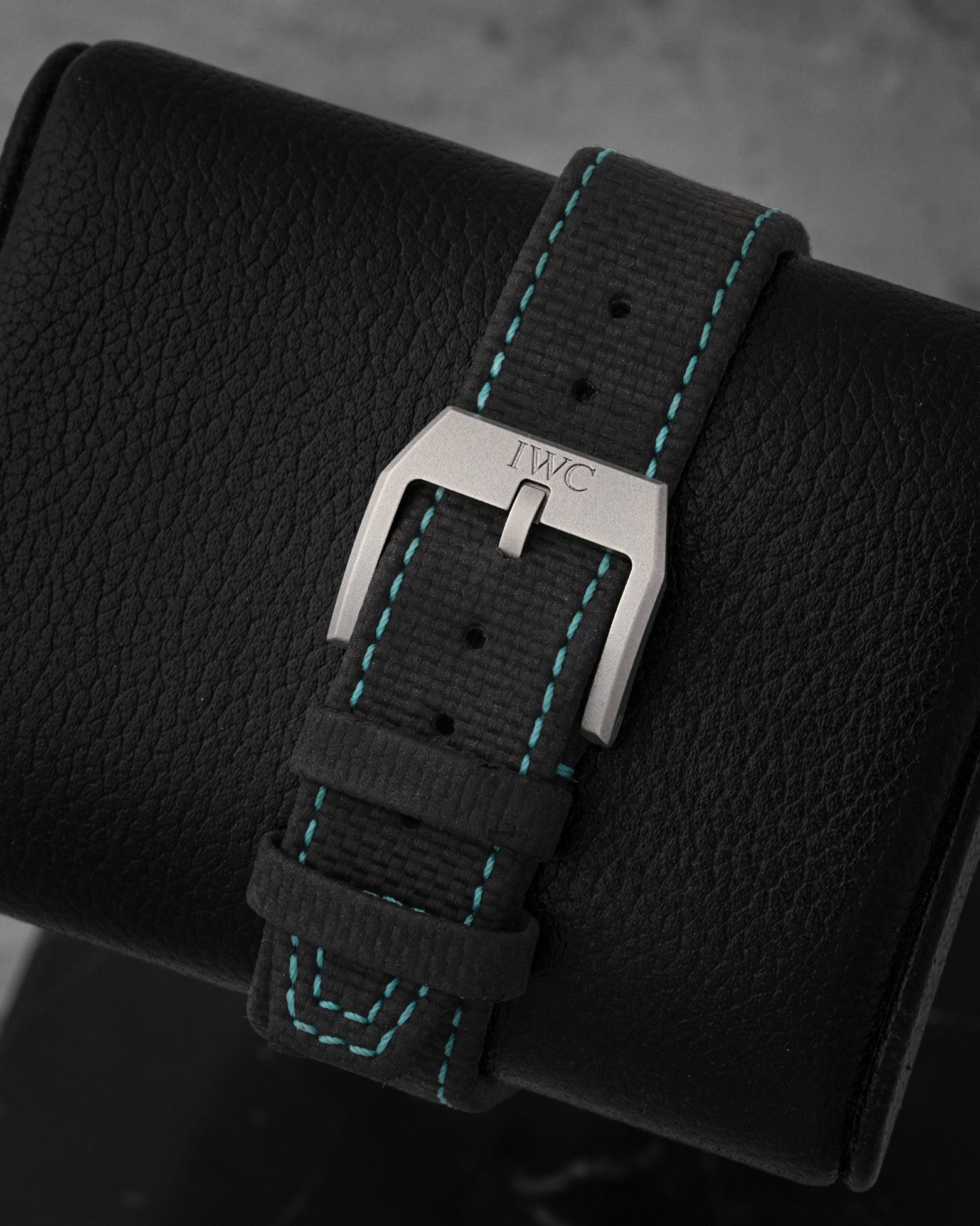 Black embossed calfskin leather strap with green contrast stitching and titanium pin buckle
