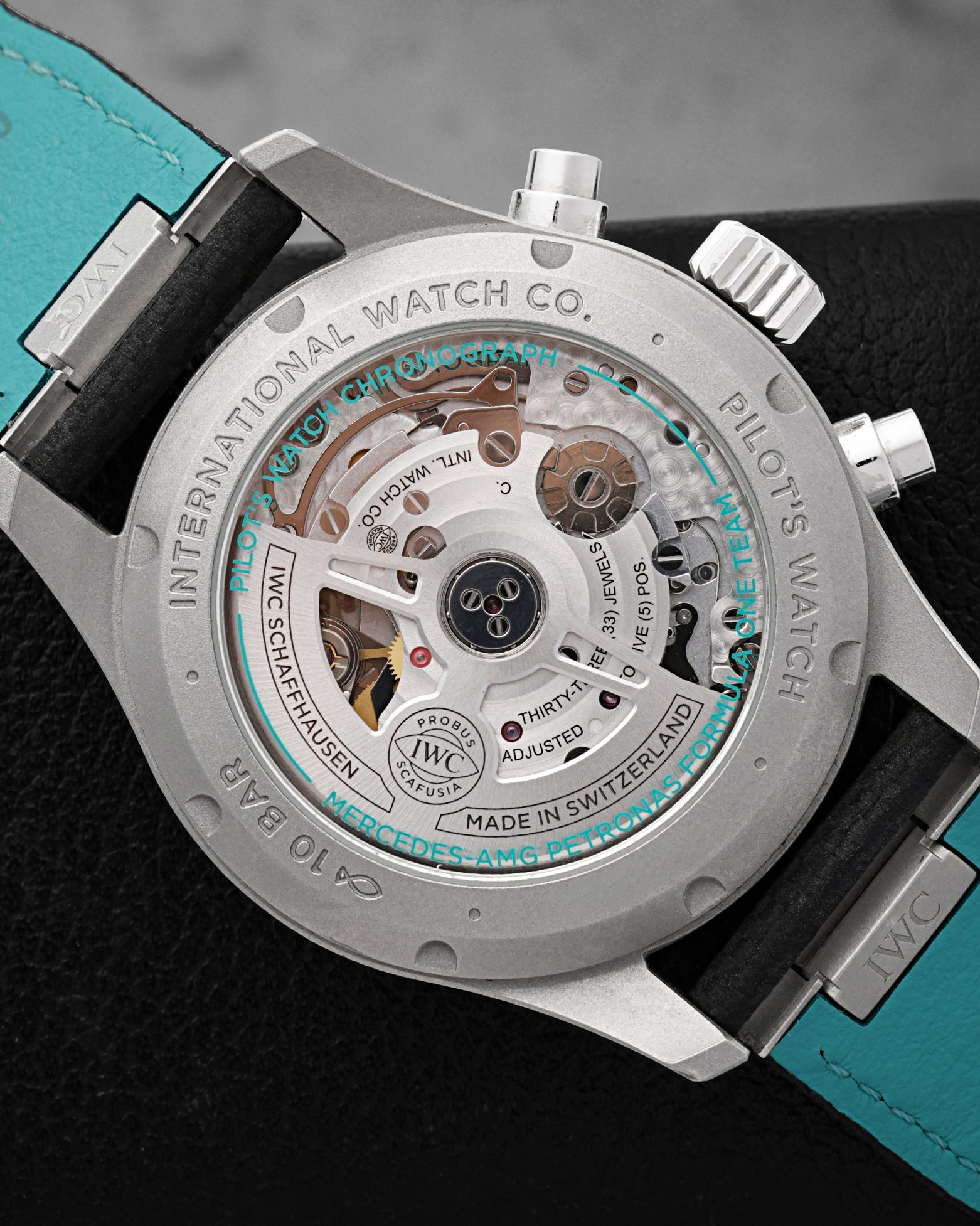 Sapphire glass case back revealing the IWC-manufactured 69385 calibre movement with Petronas green details