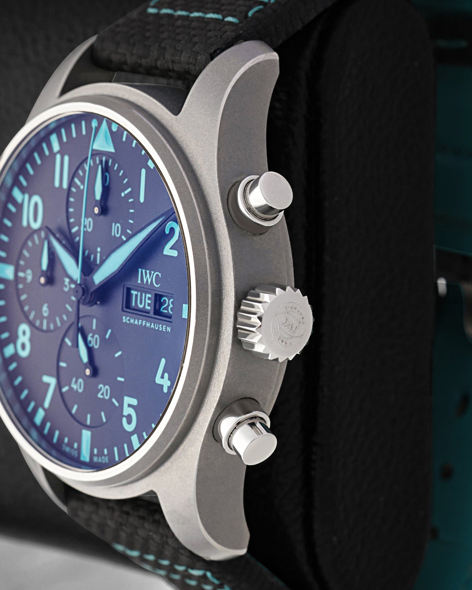 Close-up view of the screw-in crown and chronograph pushers on a titanium IWC Pilot's Watch