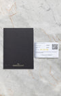 Official Jaeger-LeCoultre international warranty card and user manual booklet on a marble surface