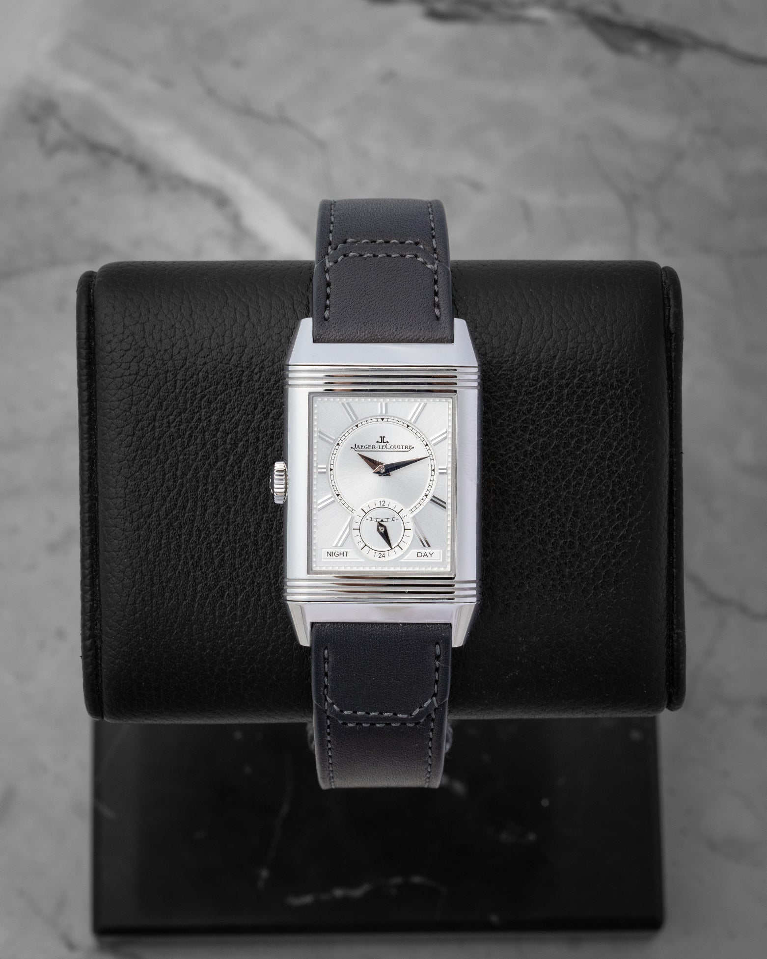 The reversed side of the Jaeger-LeCoultre Duoface watch, showcasing a silvered-grey sunray dial with a 24-hour night and day indicator