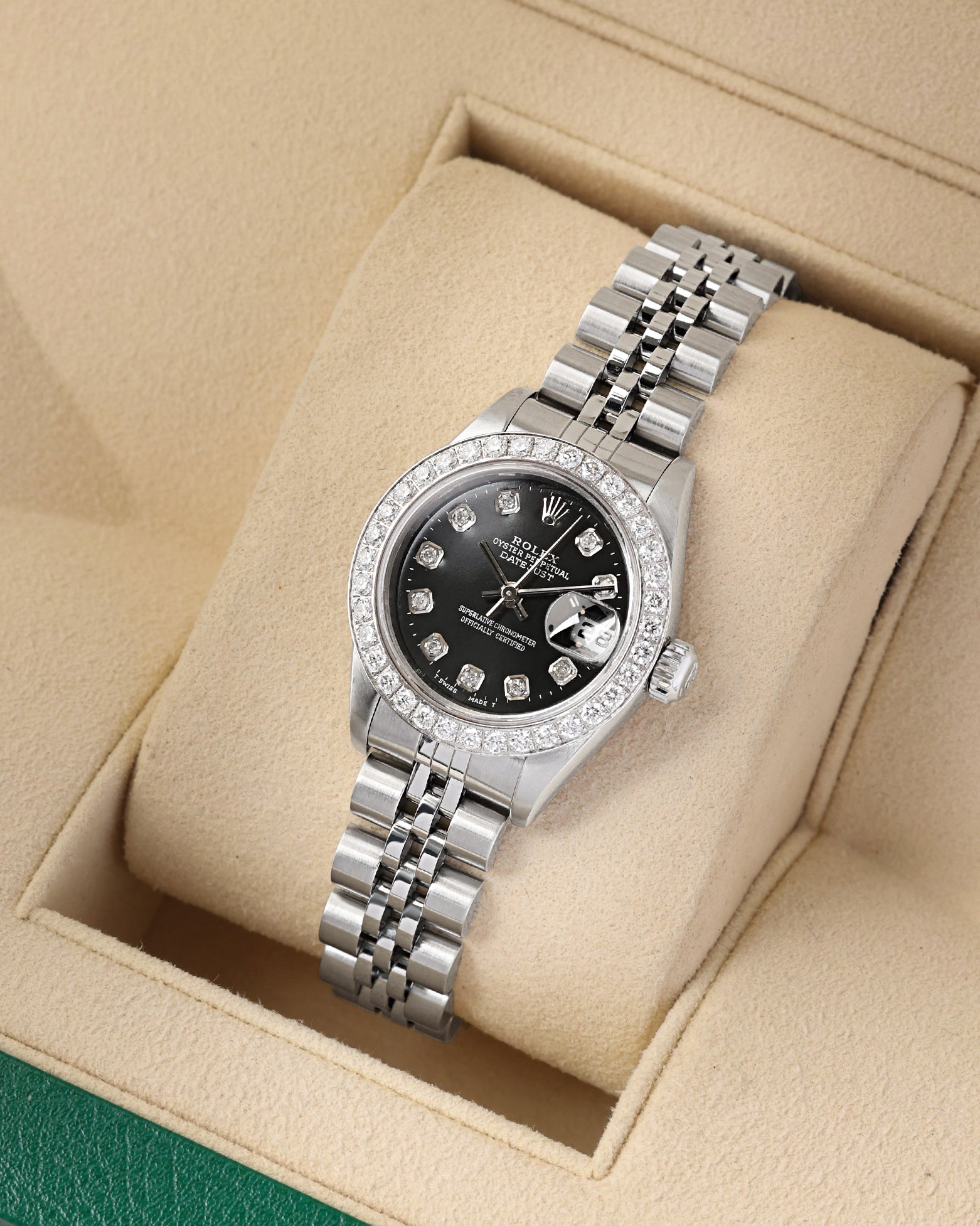 A high-angle three-quarter portrait of the 26mm stainless steel watch case showcasing the custom diamond dial configuration paired with a classic steel Jubilee bracelet