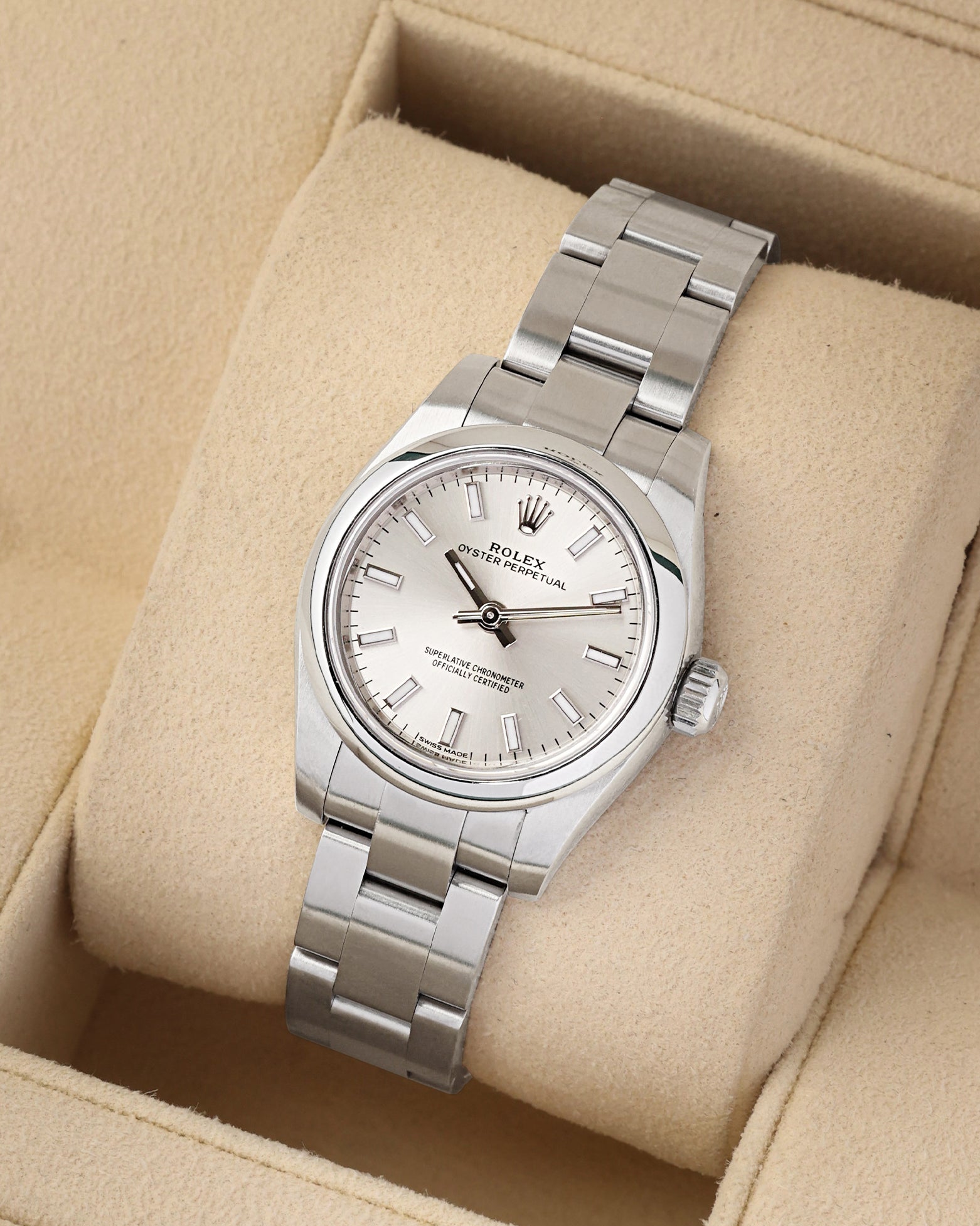 e-commerce portrait of the 26mm stainless steel watch case showcasing the satin-brushed finish of its solid Oystersteel links on a beige display cushion