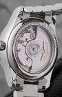 The reverse profile of the watch chassis through a sapphire exhibition caseback revealing the automatic caliber L899.5 movement decorated with perlage circular graining and a custom openworked rotor