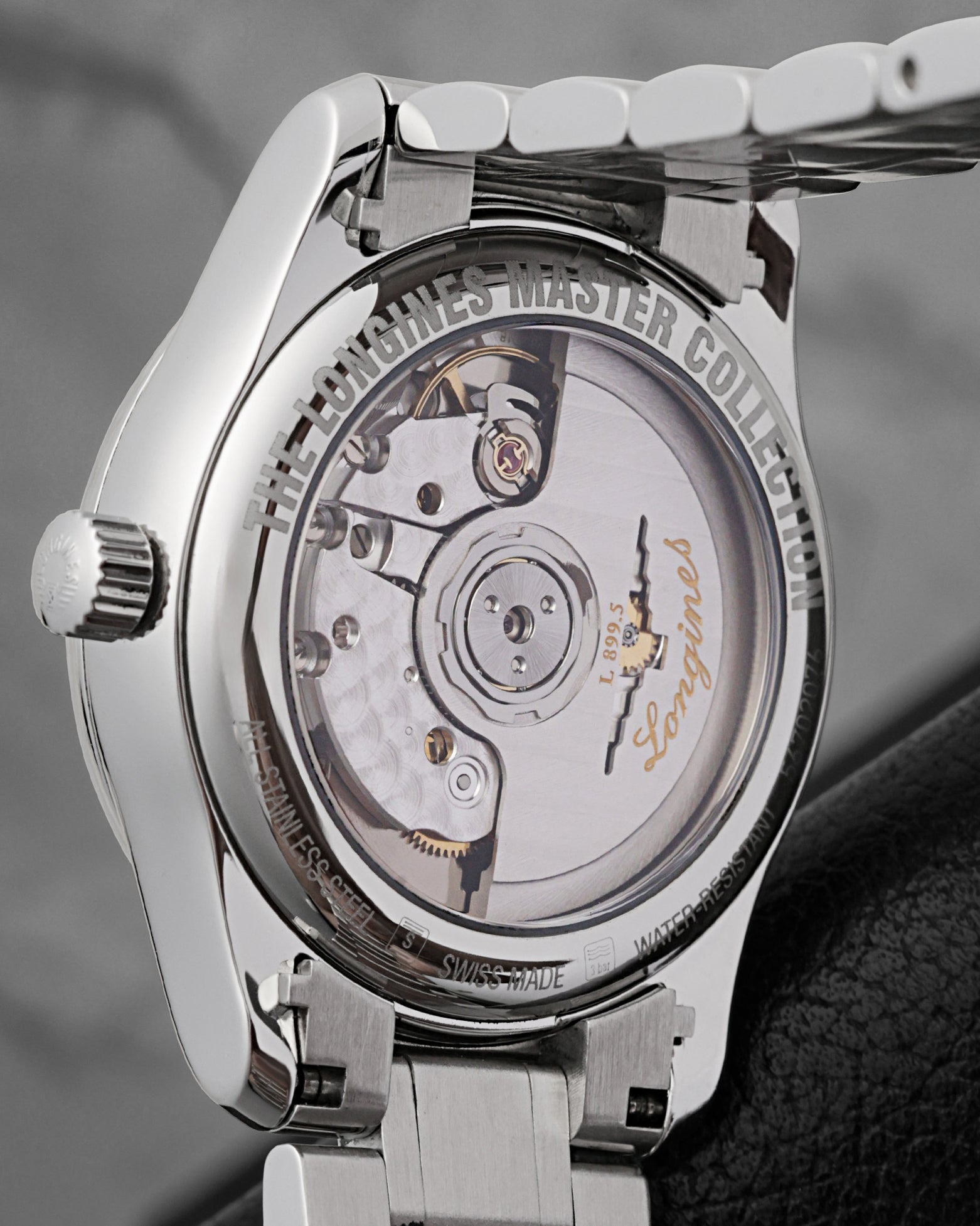 The reverse profile of the watch chassis through a sapphire exhibition caseback revealing the automatic caliber L899.5 movement decorated with perlage circular graining and a custom openworked rotor