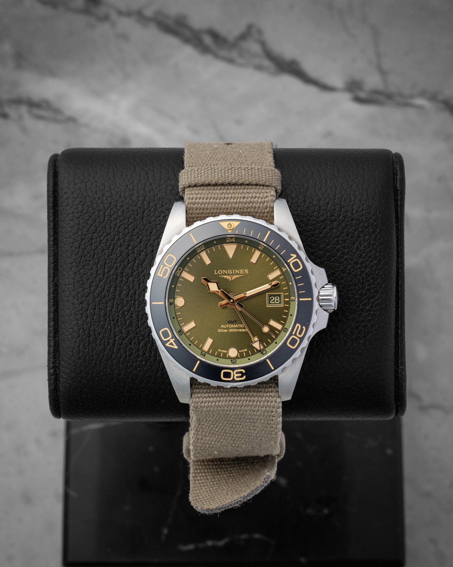 Green dial Longines HydroConquest GMT 41mm watch, model L3.790.4.06.2, on a khaki green fabric strap at Noah's Fine Watches & Jewelry in Dallas