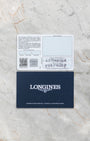 Longines HydroConquest GMT official warranty card and blue booklet displayed at Noah's Fine Watches & Jewelry