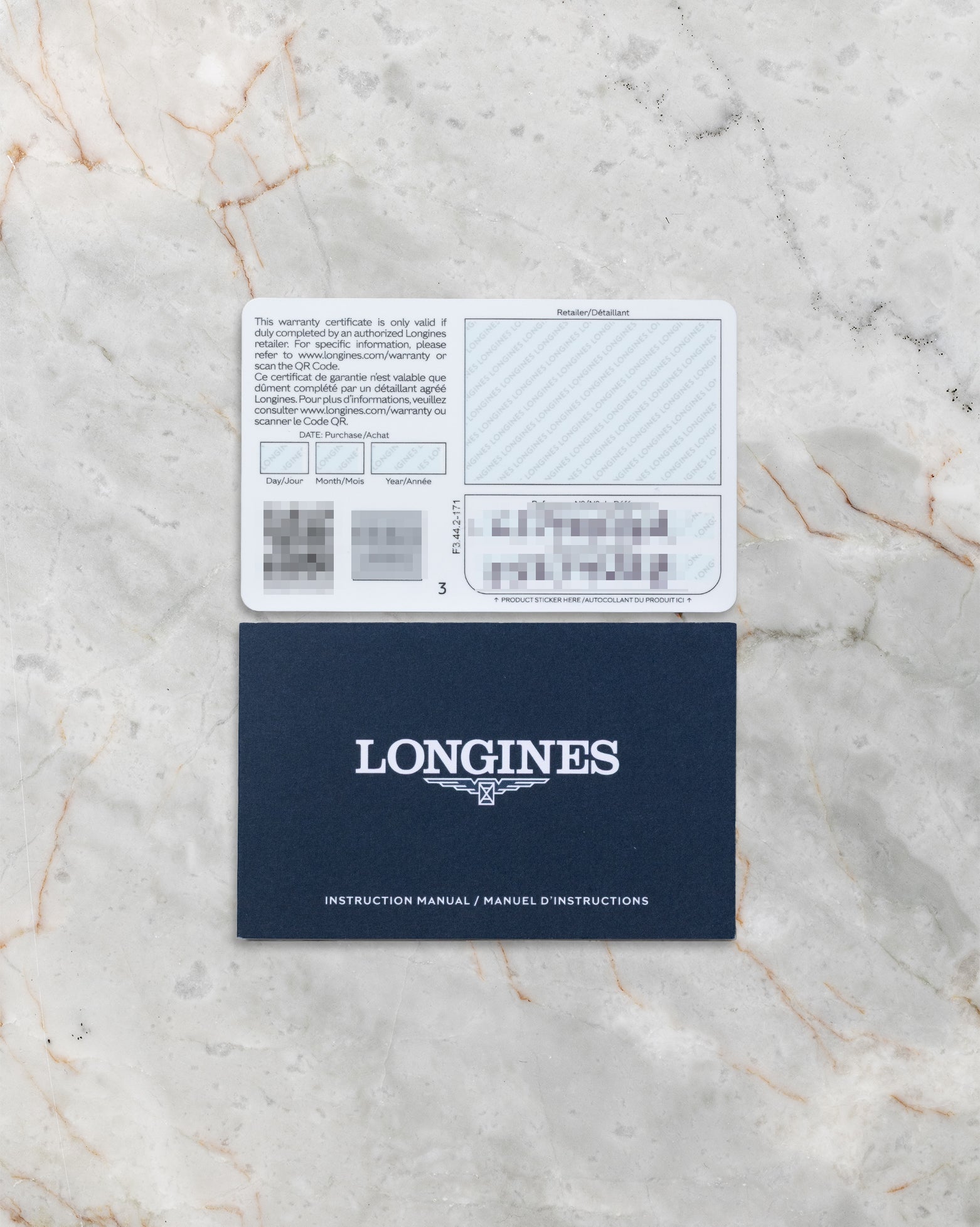 Longines HydroConquest GMT official warranty card and blue booklet displayed at Noah's Fine Watches & Jewelry
