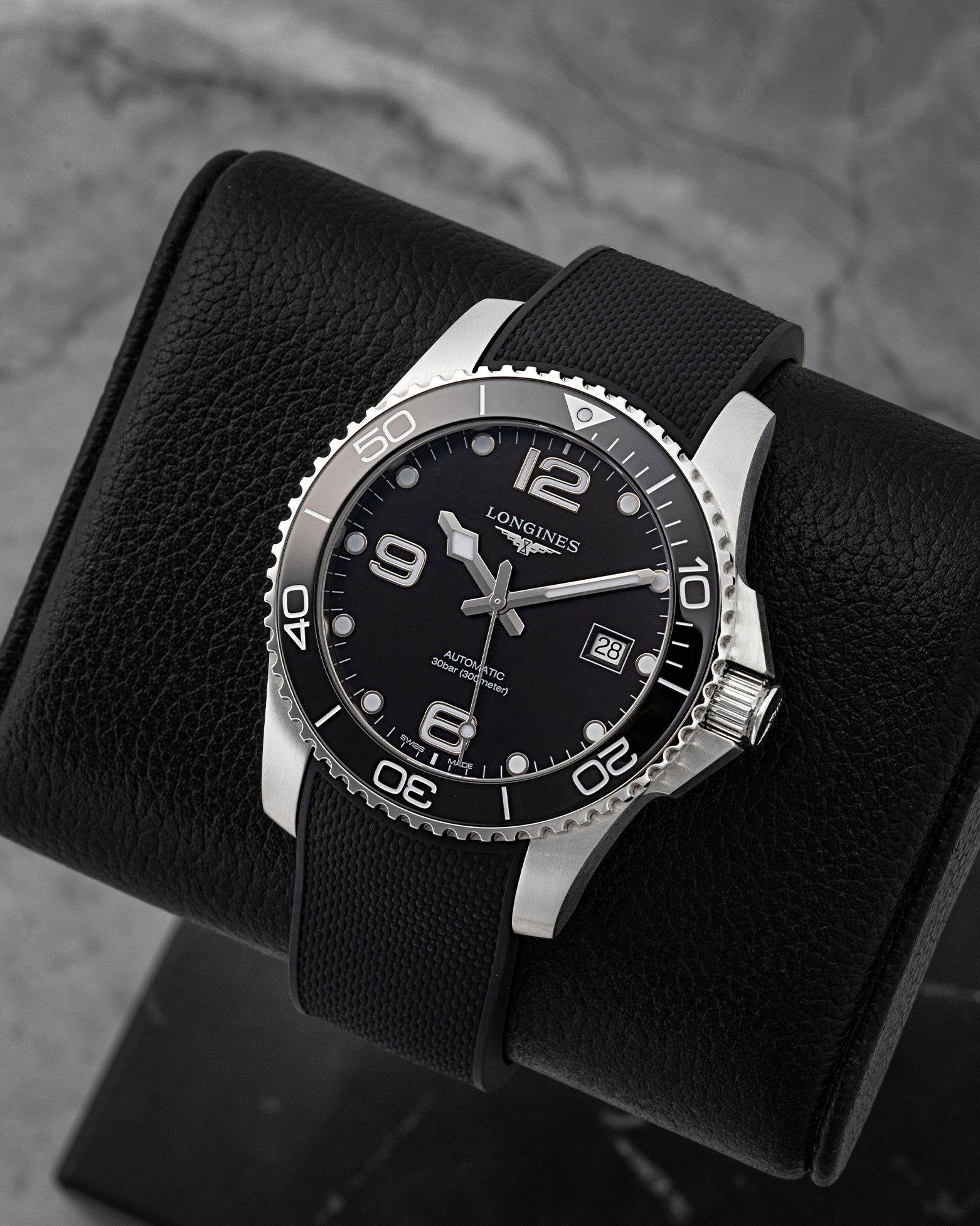 Angled front view of pre-owned Longines HydroConquest L3.781.4.56.9 featuring a black dial, Arabic numerals, date display, and unidirectional rotating ceramic bezel