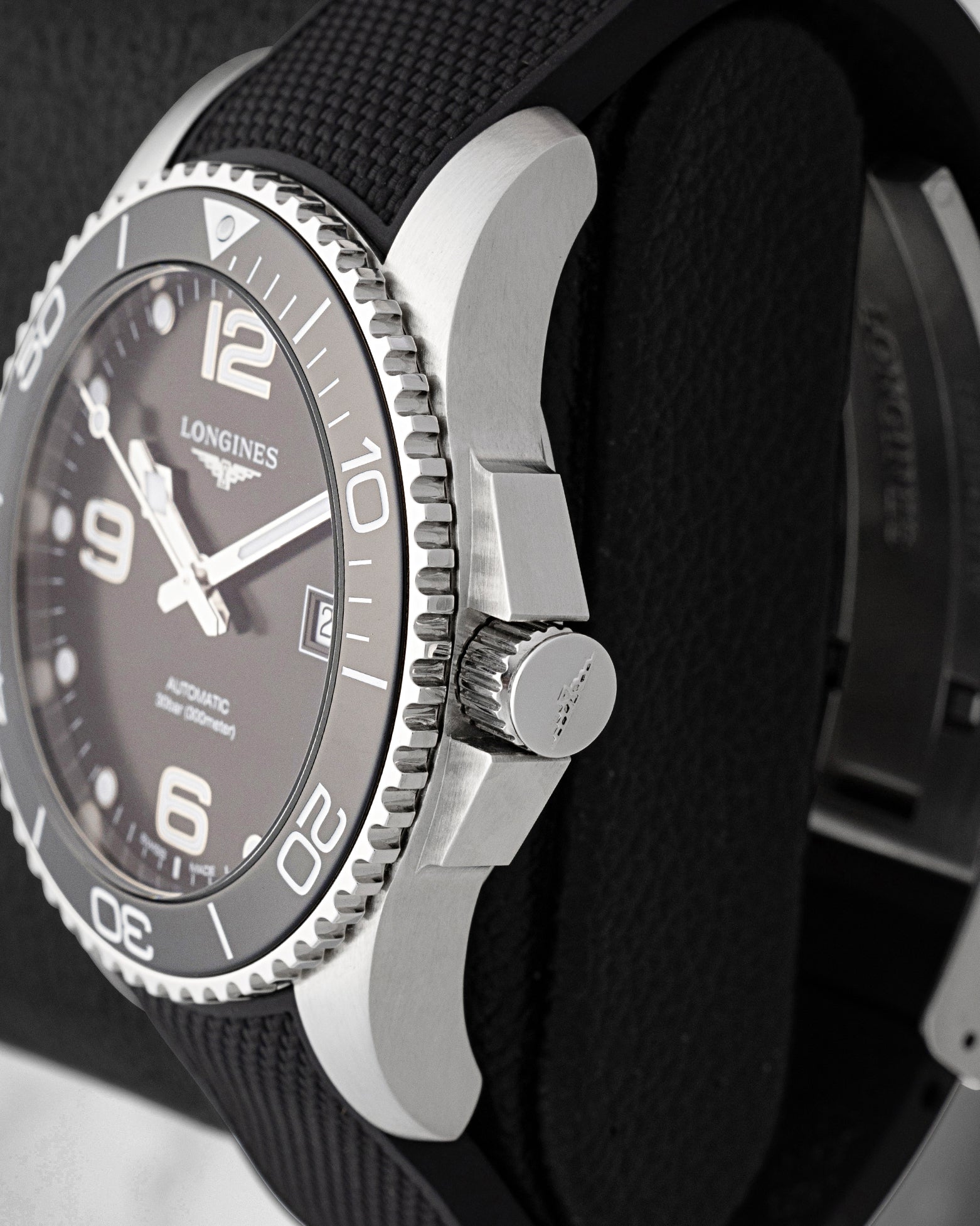 Side profile view showing the protective crown guards, screw-down winding crown, and stainless steel case on Longines HydroConquest L3.781.4.56.9