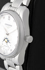 Close-up right profile view of the slim steel watch head focusing on the high-polished bezel edge and the textured push-pull winding crown signed with the winged hourglass crest