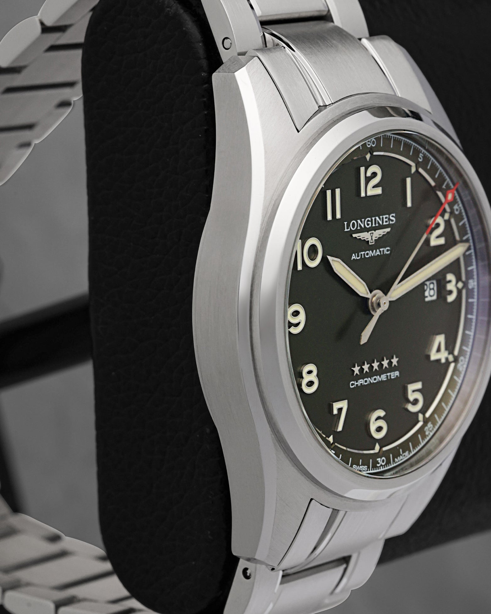 Left-side profile view of the 42mm steel watch chassis showcasing the fine longitudinal satin graining across the case flank and the sharp, mirror-polished bevel lines on the lugs