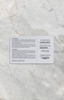 A top-down flat lay view of the official white and grey Longines international guarantee smart card displaying printed model calibration and serial information