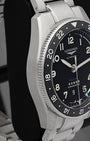 Left-side profile view of the steel watch chassis showcasing the fine longitudinal satin finish across the case flank and the sharp, mirror-polished bevel lines on the lugs