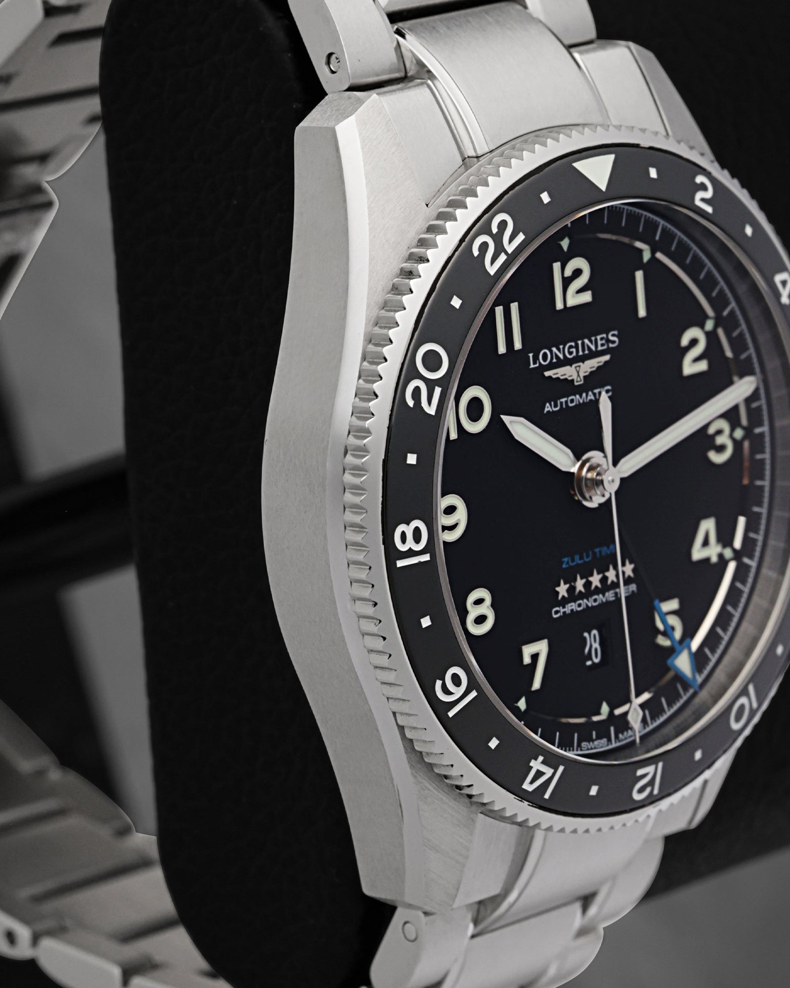Left-side profile view of the steel watch chassis showcasing the fine longitudinal satin finish across the case flank and the sharp, mirror-polished bevel lines on the lugs