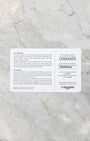 A top-down flat lay view of the official white and grey Longines international guarantee smart card displaying printed model calibration and serial information