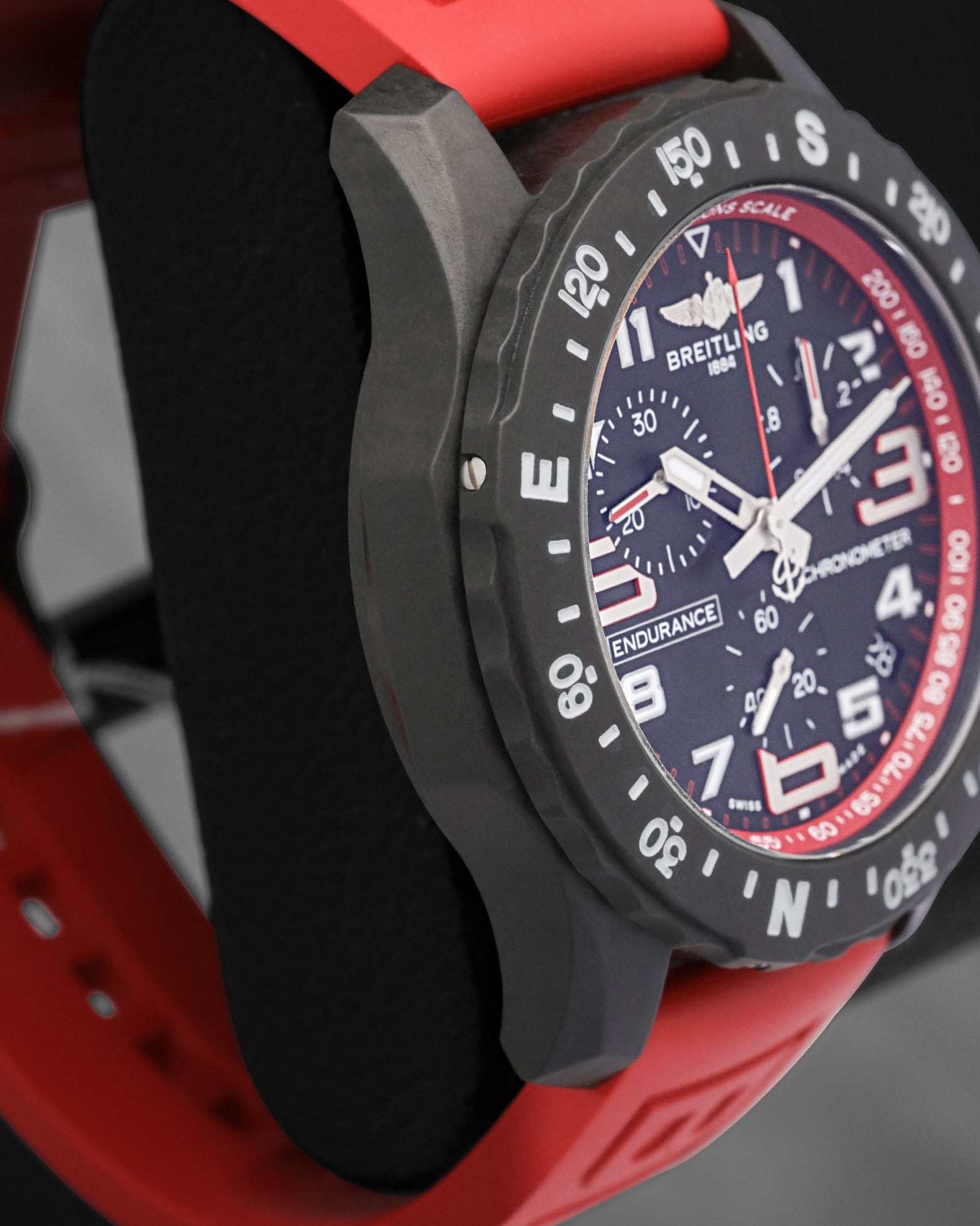 Left side perspective view highlighting the matte black finish of the case and the bidirectional rotating bezel engraved with compass points