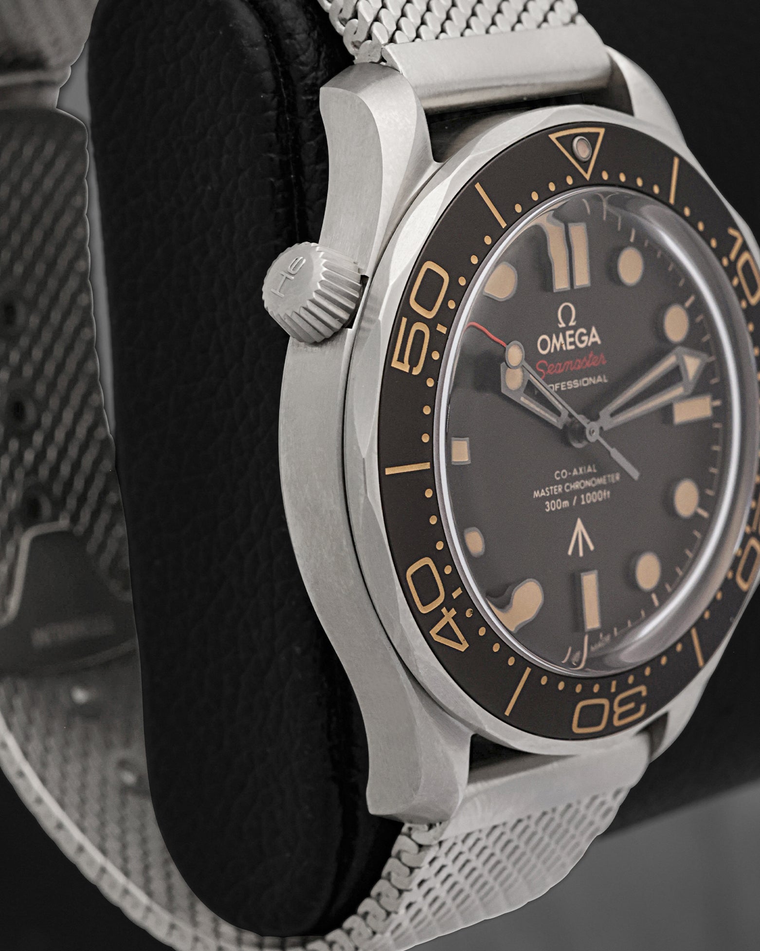 Left side perspective showcasing the clean matte finish of the lightweight titanium case and the prominent conical helium escape valve at 10 o'clock