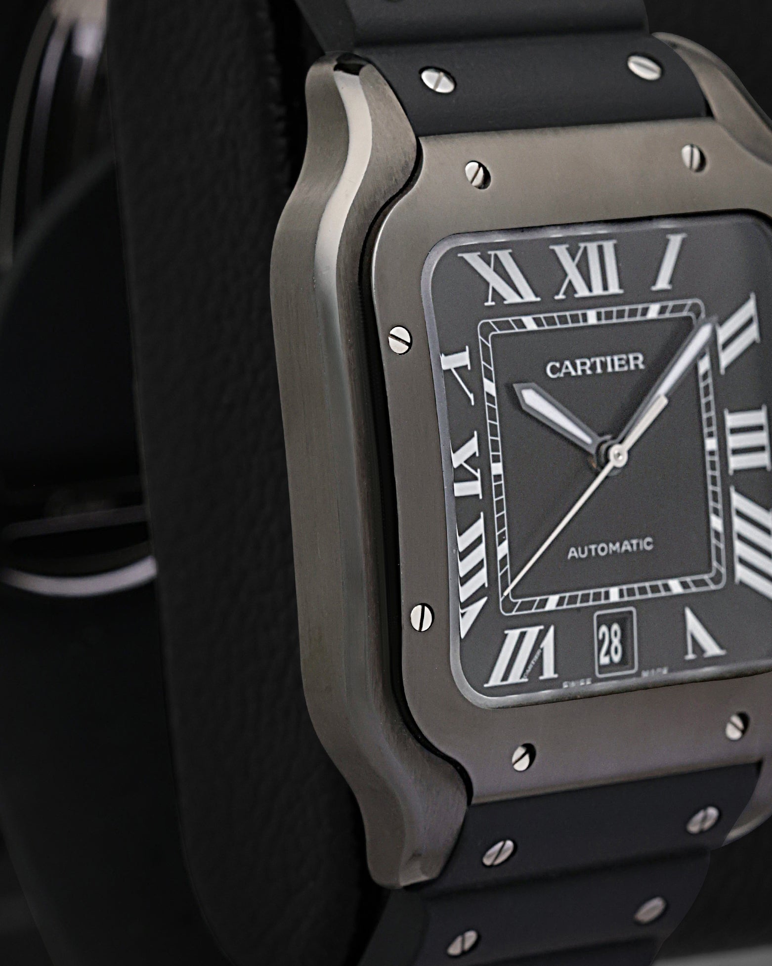 Left side perspective highlighting the ergonomic curved profile, square case shape, and distinctive exposed screws on the black ADLC bezel