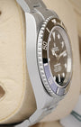 Left side perspective showcasing the high-polish finish on the steel case side and the distinct knurled edge profile of the ceramic bezel